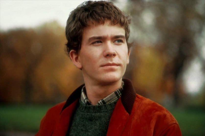 Portrait of a man wearing a green sweater outdoors
